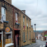 The view down Queen Street- house buildings and a pavement