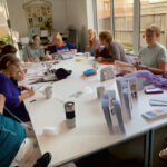 Group activity at the Cluntergate Centre- group of people sat around a table making things