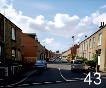 View of a residential street with cars parked outside houses